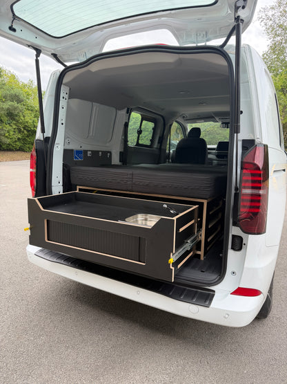 Discovery camping pod in the back of a work van with the kitchen out, a weekend camper with no permanent conversion